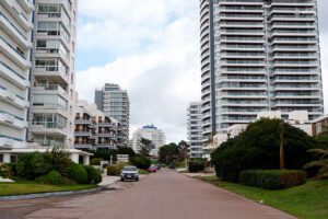 Playa Brava: A residential street in Playa Brava, where houses and apartment buildings share the block, a short walk from the beach.